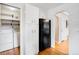 This kitchen includes white cabinets and black refrigerator; laundry room is in the background at 2255 Perry St, Denver, CO 80212