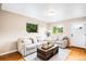 Comfortable living room featuring hardwood floors, neutral decor, and lots of natural light at 2255 Perry St, Denver, CO 80212