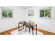 A home office has wood floors and is decorated with a wooden desk and neutral colors at 2255 Perry St, Denver, CO 80212