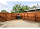 An outdoor patio has brick pavers and a grill surrounded by a wooden fence at 2255 Perry St, Denver, CO 80212