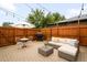 An outdoor patio is decorated with string lights, an umbrella, and patio furniture at 2255 Perry St, Denver, CO 80212