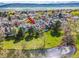 Aerial view of a townhome community with a picturesque pond and mountain views in the background at 10433 Red Mountain W, Littleton, CO 80127