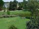Community park with pond and bench nestled among trees for peaceful relaxation and enjoying nature at 10433 Red Mountain W, Littleton, CO 80127