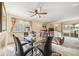 Inviting dining area with modern glass table and comfortable seating, adjacent to living area at 10433 Red Mountain W, Littleton, CO 80127