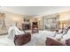 Cozy living room boasts a brick fireplace, comfortable seating, and sliding door to a balcony at 10433 Red Mountain W, Littleton, CO 80127