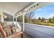 Inviting covered porch features wooden chairs, string lights, and a scenic outdoor view at 10433 Red Mountain W, Littleton, CO 80127