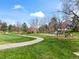 Community walking path winding through a lush green park and playground, inviting outdoor recreation at 10433 Red Mountain W, Littleton, CO 80127
