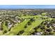 Picturesque aerial view of the golf course community, showcasing lush green fairways, ponds, and beautiful homes at 735 Orchard Ct, Louisville, CO 80027
