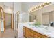 Well-lit bathroom with a glass shower, double sinks, and neutral decor creating a clean and inviting space at 735 Orchard Ct, Louisville, CO 80027