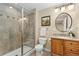 Bathroom with a glass enclosed shower, neutral walls, updated fixtures, and a framed mirror above the vanity at 735 Orchard Ct, Louisville, CO 80027