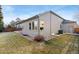 Back exterior view showing landscaping, and patio with neutral siding and roof at 735 Orchard Ct, Louisville, CO 80027