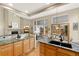 Stylish kitchen with granite countertops, stainless steel appliances, and a view of the fireplace in the living room at 735 Orchard Ct, Louisville, CO 80027