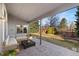 Covered patio featuring stamped concrete, outdoor seating, and lush landscaping, perfect for relaxation and entertaining at 735 Orchard Ct, Louisville, CO 80027