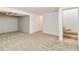 Spacious carpeted basement featuring a staircase and access to other areas of the home at 227 Olympus Cir, Lone Tree, CO 80124