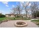 Spacious backyard with fire pit, garden beds and mature trees at 2020 Routt St, Lakewood, CO 80215
