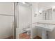 Bathroom with glass enclosed shower, pedestal sink, and unique tile accents at 2020 Routt St, Lakewood, CO 80215