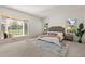 Bright bedroom featuring a bay window seat, neutral carpet, and stylish decor at 2020 Routt St, Lakewood, CO 80215