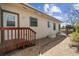 Side of the home with wooden porch and entrance with lovely landscaping at 2020 Routt St, Lakewood, CO 80215