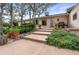 Home exterior featuring a front entrance with steps, landscaping, and patio area at 2020 Routt St, Lakewood, CO 80215