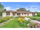 Charming ranch style home with lovely flower beds and a welcoming walkway to the front door at 2020 Routt St, Lakewood, CO 80215