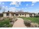 Ranch style home with a charming walkway and well-maintained landscaping at 2020 Routt St, Lakewood, CO 80215