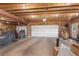 Spacious three car garage with exposed rafters and shelving at 2020 Routt St, Lakewood, CO 80215