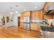 Bright kitchen with stainless appliances, granite countertops, and wood cabinetry at 2020 Routt St, Lakewood, CO 80215