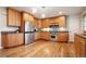 Spacious kitchen boasts stainless steel appliances, wood cabinets, and granite countertops at 2020 Routt St, Lakewood, CO 80215
