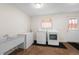 Clean laundry room with washer, dryer, large sink, and door to the outside at 2020 Routt St, Lakewood, CO 80215