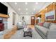 Bright living room with wood paneling, stone fireplace, and hardwood floors at 2020 Routt St, Lakewood, CO 80215