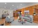Bright living room with wood accents, a gray sofa, and stylish decor at 2020 Routt St, Lakewood, CO 80215