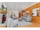 Inviting living room featuring wood paneling, a fireplace, and comfortable seating at 2020 Routt St, Lakewood, CO 80215