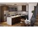 Modern kitchen with stone counter tops, dark wood cabinets and stainless steel appliances at 5764 W 92Nd Ave, Westminster, CO 80031