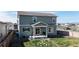 The home's back exterior features a small yard and patio area with a grill at 17947 E 95Th Ave, Commerce City, CO 80022
