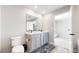 A bathroom with double sinks, a toilet, and a mirror at 17947 E 95Th Ave, Commerce City, CO 80022