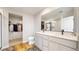 A modern bathroom with double sinks, a walk-in closet, and a separate toilet room at 17947 E 95Th Ave, Commerce City, CO 80022