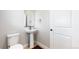 Modern half-bathroom with pedestal sink, and sleek fixtures, and neutral paint at 17947 E 95Th Ave, Commerce City, CO 80022