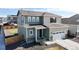 Attractive two-story home showcasing mixed siding, stone accents, a two-car garage, and a well-maintained landscaped yard at 17947 E 95Th Ave, Commerce City, CO 80022