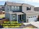 Charming two-story home with a two car garage, inviting front porch and stone accents under a blue sky at 17947 E 95Th Ave, Commerce City, CO 80022