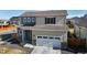Beautiful two-story home with a two-car garage and manicured front yard at 17947 E 95Th Ave, Commerce City, CO 80022