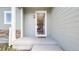 Charming front porch with a decorative welcome mat and exterior lighting at 17947 E 95Th Ave, Commerce City, CO 80022