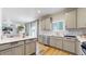 Modern kitchen with gray cabinets, stainless steel appliances, tile backsplash, and center island at 17947 E 95Th Ave, Commerce City, CO 80022