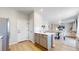 Open-concept kitchen with gray cabinets, stainless appliances, and view into the living area at 17947 E 95Th Ave, Commerce City, CO 80022