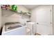 Functional laundry room with modern washer and dryer, plus storage shelves at 17947 E 95Th Ave, Commerce City, CO 80022