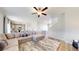 Inviting living area leads to a modern kitchen, featuring an oversized sectional sofa, and wood-look floors at 17947 E 95Th Ave, Commerce City, CO 80022