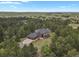 Breathtaking aerial view of an estate surrounded by lush greenery, mature trees, and rolling hills in the distance at 1972 Gold Camp Way, Franktown, CO 80116