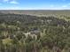 Breathtaking aerial view of a secluded property showcasing a stunning home embraced by lush, mature trees at 1972 Gold Camp Way, Franktown, CO 80116