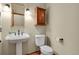 Bathroom featuring pedestal sink, decorative mirror and lighting, with neutral paint at 1972 Gold Camp Way, Franktown, CO 80116