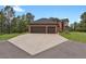 Spacious three-car garage with a large driveway leading to the brick home at 1972 Gold Camp Way, Franktown, CO 80116