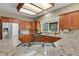 Kitchen has wood cabinets, granite counters, stainless appliances, and a gas cooktop on the island at 1972 Gold Camp Way, Franktown, CO 80116